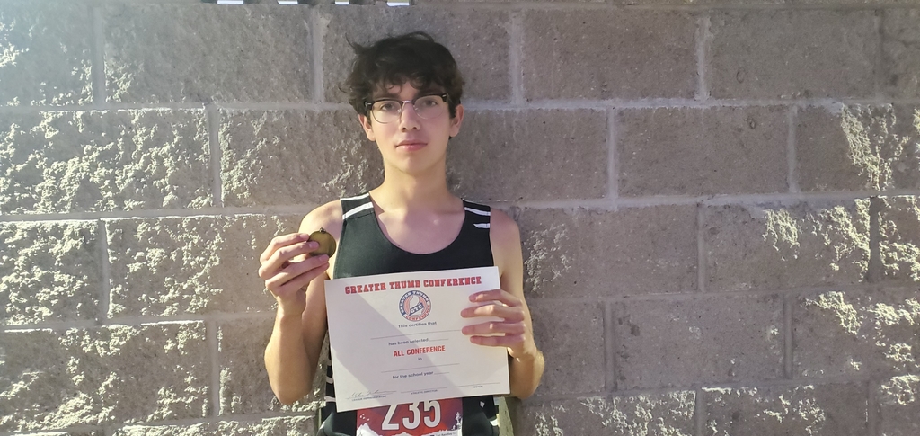 Maddox Fabbro with All Confrence certificate and medal