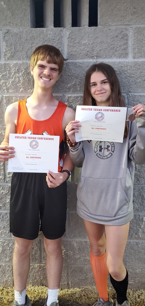Ashley Shindorf and Nick Tallman with all confrence certificates and medals