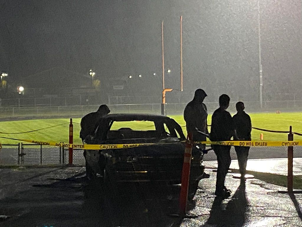 car in and students in the rain at the car smash