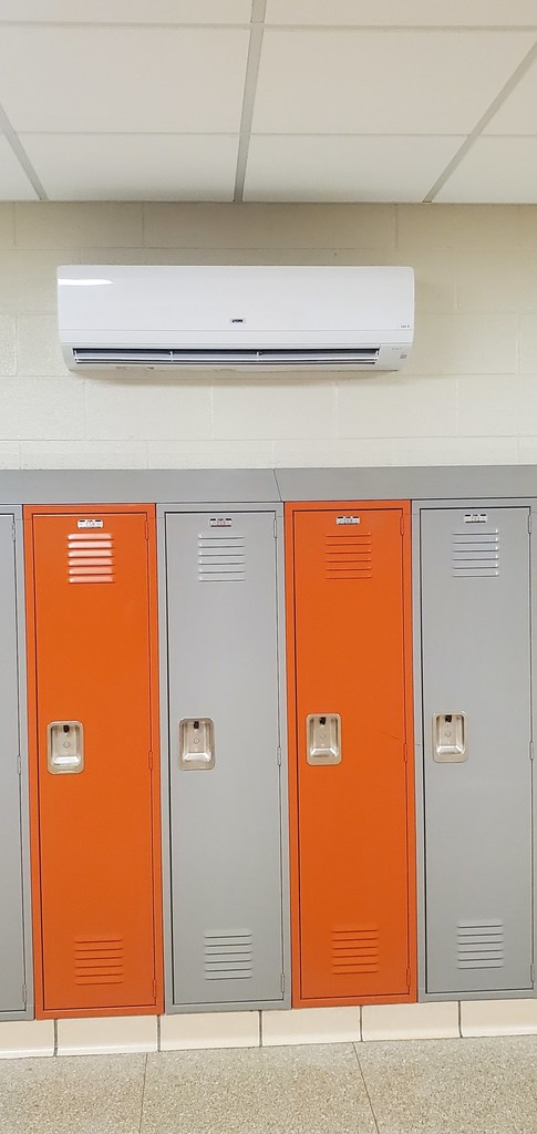 orange and grey lockers with new air conditioning units being installed.